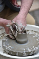 Fototapeta na wymiar Detail shot with hands of a potter making handmade pottery
