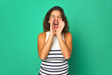 Young caucasian woman isolated shouting excited to front.