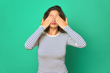 Young caucasian woman isolated afraid covering eyes with hands.