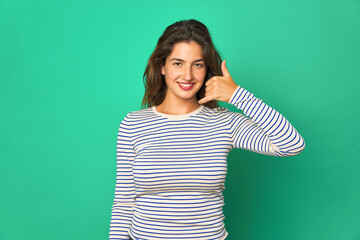 Fototapeta premium Young caucasian woman isolated showing a mobile phone call gesture with fingers.