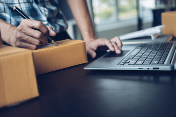 Close up business man hands freelancer sme warehouse checking email confirm order in laptop, small...