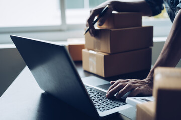 Close up business man hands freelancer sme warehouse checking email confirm order in laptop, small...