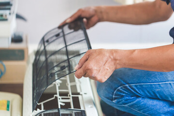 Male technician cleaning air conditioner indoors, Repairman washing dirty compartments air conditioner, Maintenance and repairing concepts
