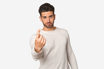 Young handsome man isolated pointing with finger at you as if inviting come closer.