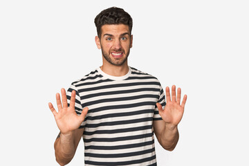 Young handsome man isolated rejecting someone showing a gesture of disgust.
