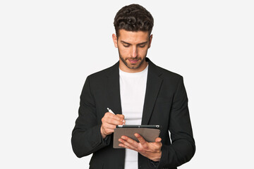 Young businessman excelling in his work, utilizing a tablet with modern technology for enhanced productivity and organization.