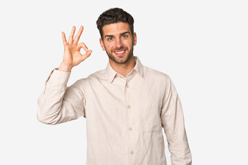 Young handsome man isolated cheerful and confident showing ok gesture.