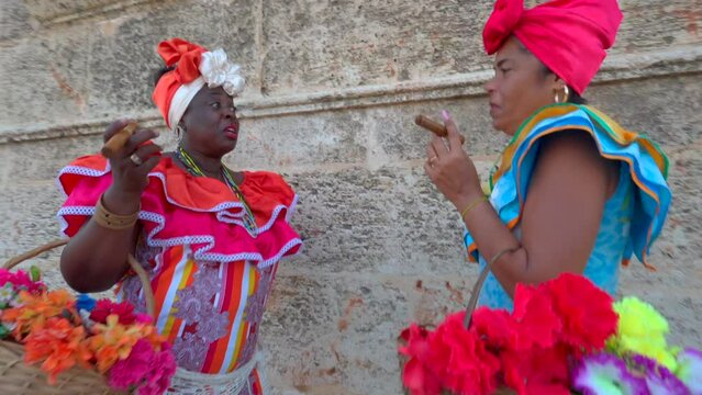 Two Cuban canasteras with habano,flowers and typical costume
