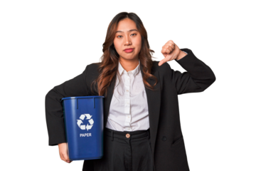 A young business asian woman holding a paper bin for recycle A young business asian woman holding a paper showing a dislike gesture, thumbs down. Disagreement concept.