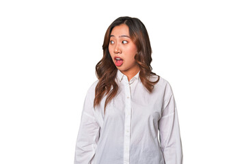 A young chinese woman being shocked because of something she has seen.