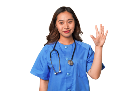 A young nurse chinese woman smiling cheerful showing number five with fingers.