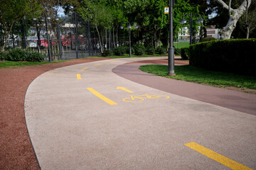 Highlighted with yellow paint cycle path in the city park.