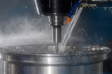 The  CNC milling machine cutting the magnesium alloy wheel part with ball end mill tool.