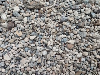 Gravel is small stones formed by the natural process of rock erosion. Gravel can be found in rivers, beaches, or even on roads as a hardening agent. Smooth and colorful pebbles.
