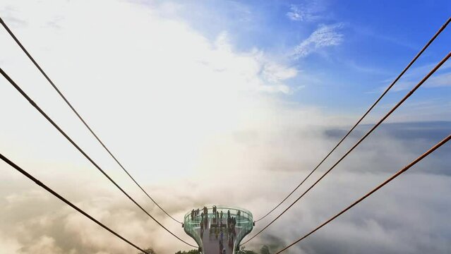 Time Lapse of Beautiful top view of sea of fog at Ai Yerweng Skywalk in Yala province, the longest skywalk in Asia. Tourists visit the landmark above forest during sunrise.