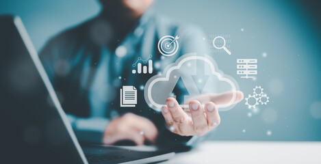 Businessman use computer laptop with virtual cloud computing to download upload or sync data information on system network application. Technology data transformation concept, Clouding data transfer.