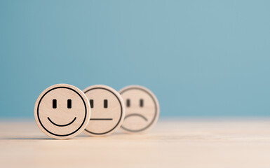 Wooden label with happy normal and sad face icons for experience survey services and products...
