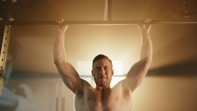 Young handsome man with bare muscular torso doing bar pull-ups in sunrays. Face muscles are tense. Man exercises patiently, putting efforts to training. High quality 4k footage Generative AI