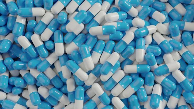 Many colorful capsule pills spin around. View from the top 
3D render animation