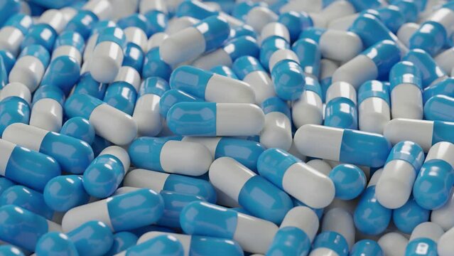 Many blue capsule pills spin around. View from the top 
3D render animation