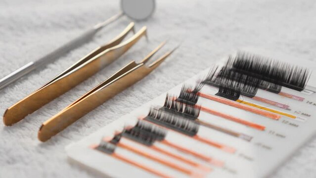 Eyelash extension tools at a lashmaker cosmetologist at beauty cosmetology clinic. Shiny artificial eyelashes of various lengths and shapes used in eyelash extensions by a professional Generative AI