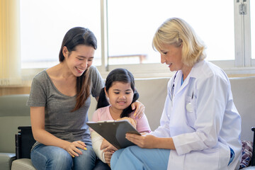 Pediatrician is closely caring and asking about sick girls symptoms, health concepts and child care.