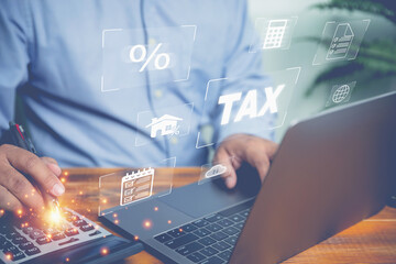 Businessman use computer online income tax forms to calculate year's tax. Those who earn income,...