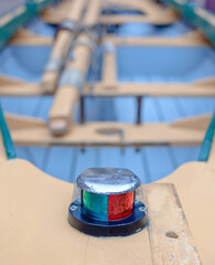 Close up view of a rustic rowboat bow and navigation light