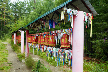 Buddhist prayer red drums with colorful ribbons. 