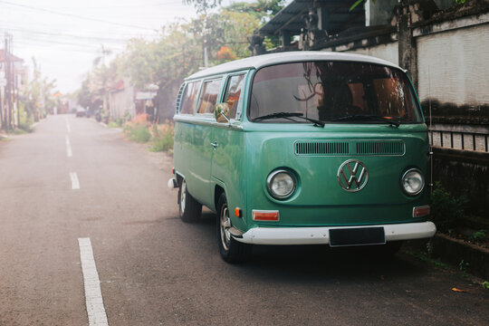 Blue retro Volkswagen bus for travel and surfing. Stylish concept of road travel and leisure
