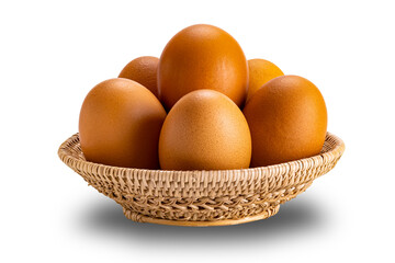 Group of raw chicken eggs in bamboo basket isolated on white background with clipping path, side view, closeup, horizontal format.