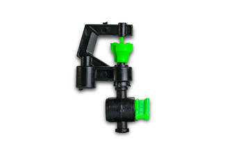 Small black and green plastic water sprinkler isolated on white background with clipping path, closeup, top view, horizontal format.