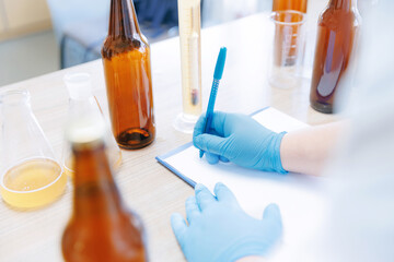 Process test production beer in laboratory, analysis drink in glasses in lab. Concept brewery food...