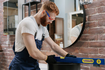 Concept repair service plumbing. Plumber install sink in bathroom loft style, checks even level of installation