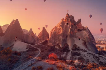 Abwaschbare Fototapete Lachsfarbe Old ancient home cave in big stone, hot air balloons fly over deep canyons, valleys Cappadocia Goreme National Park, Turkey Travel tourist concept
