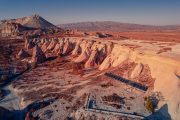 Fototapeta na wymiar Panoramic view of Goreme national park with over deep canyons, valleys sunset Cappadocia. Popular Turkey touristic destination, aerial top view drone