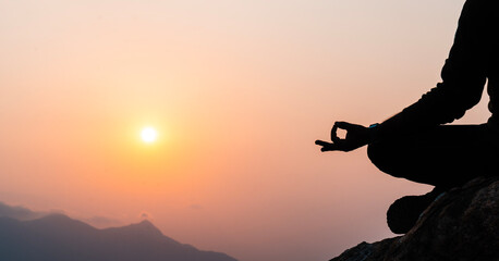 yoga pose on mountain during sunset, International yoga day concept image with copy space for text, World meditation day