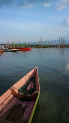 Fishing boats on the edge of Rawa Pening lake at sunrise, sunset. Rawa Pening is a lake located in three districts namely Tuntang, Ambarawa, Banyubiru Semarang.