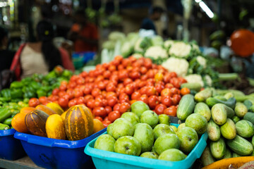 Fresh vegetables at farmers market, Yellow cucumber mango and tomato in the background