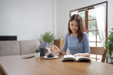 .Young asian woman reading a book at home, girl hold book Education school university college concept.concept.