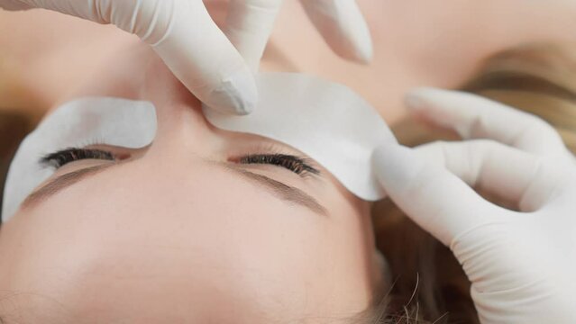 Client is relaxed and comfortable during the gentle process of eyelash extension. Beautiful woman at a reception at a beautician in a beauty salon. Relaxation and rest during the Generative AI