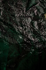 Creative image of wet green rumpled material underwater with waves, for your stylish design or illustrations.