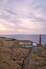 Aerial view of sunset and lilac sky over Butt of Lewis Lighthouse, Scotland 