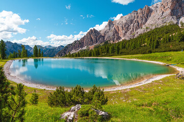 Fototapeta na wymiar Turquoise water alpine lake in Dolomites mountains, Italy. Lago Son Forca in Italian Alps in sunny day