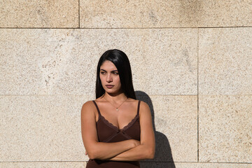 Young beautiful woman making different expressions of surprise, anger or happiness and sadness on a gray background. Concept expressions and gestures.