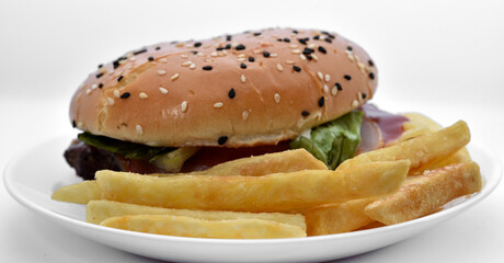 Meat burger with French fries on a white plate. Delicious fast food breakfast. Hamburger.
