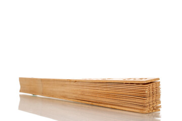 One wooden fan, macro, isolated on white background.