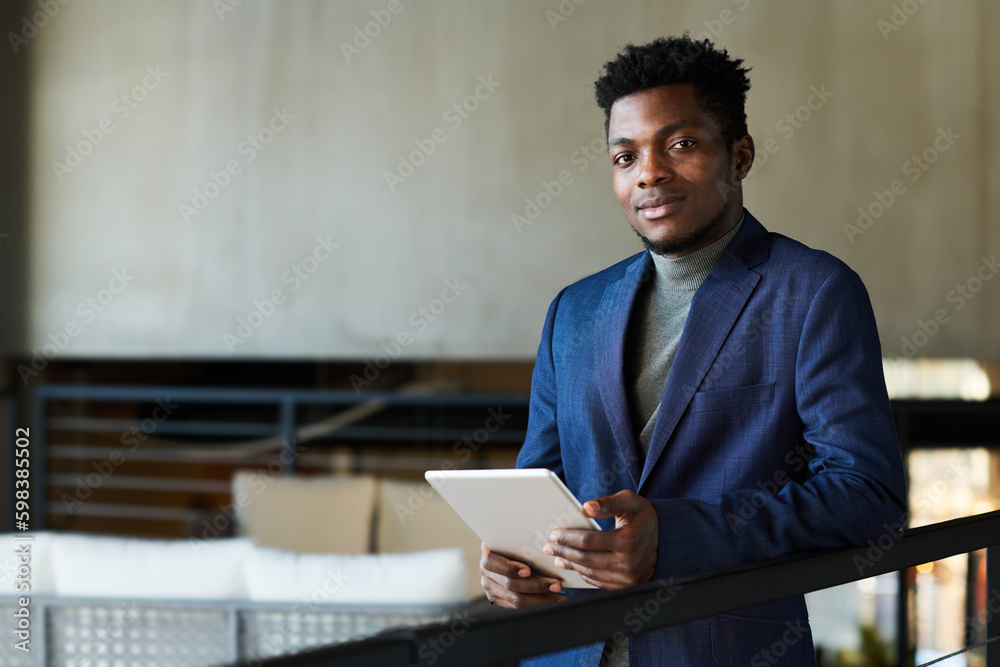 Aufkleber young african american solopreneur with tablet looking at camera while analyzing financial graphic d