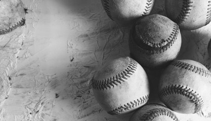 Old texture of baseball balls in black and white closeup with copy space on vintage background.