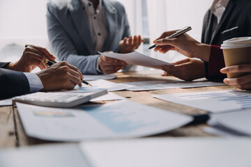 Brainstorming Collaboration and successful partnership analysis by Young business Asian people working in an office workspace